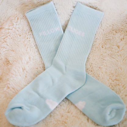 Blue cloudy pillow socks on carpet