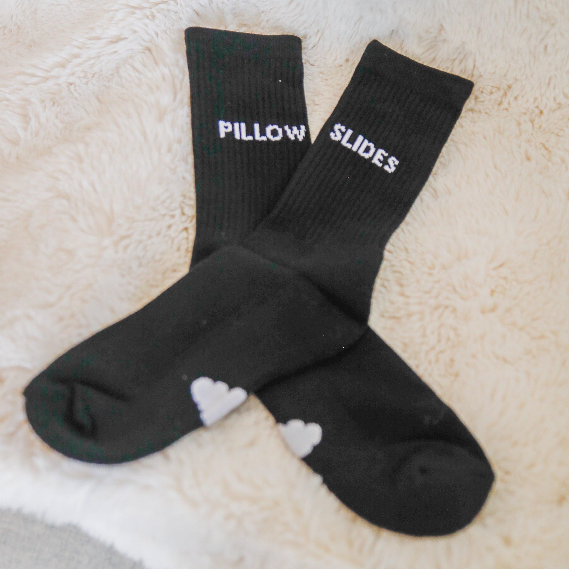 Black cloudy pillow socks on carpet