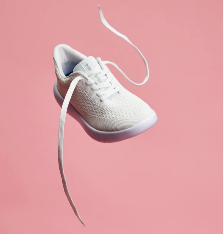 White shoes on pink backdrop