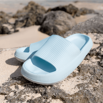 Women's blue slides on beach rocks