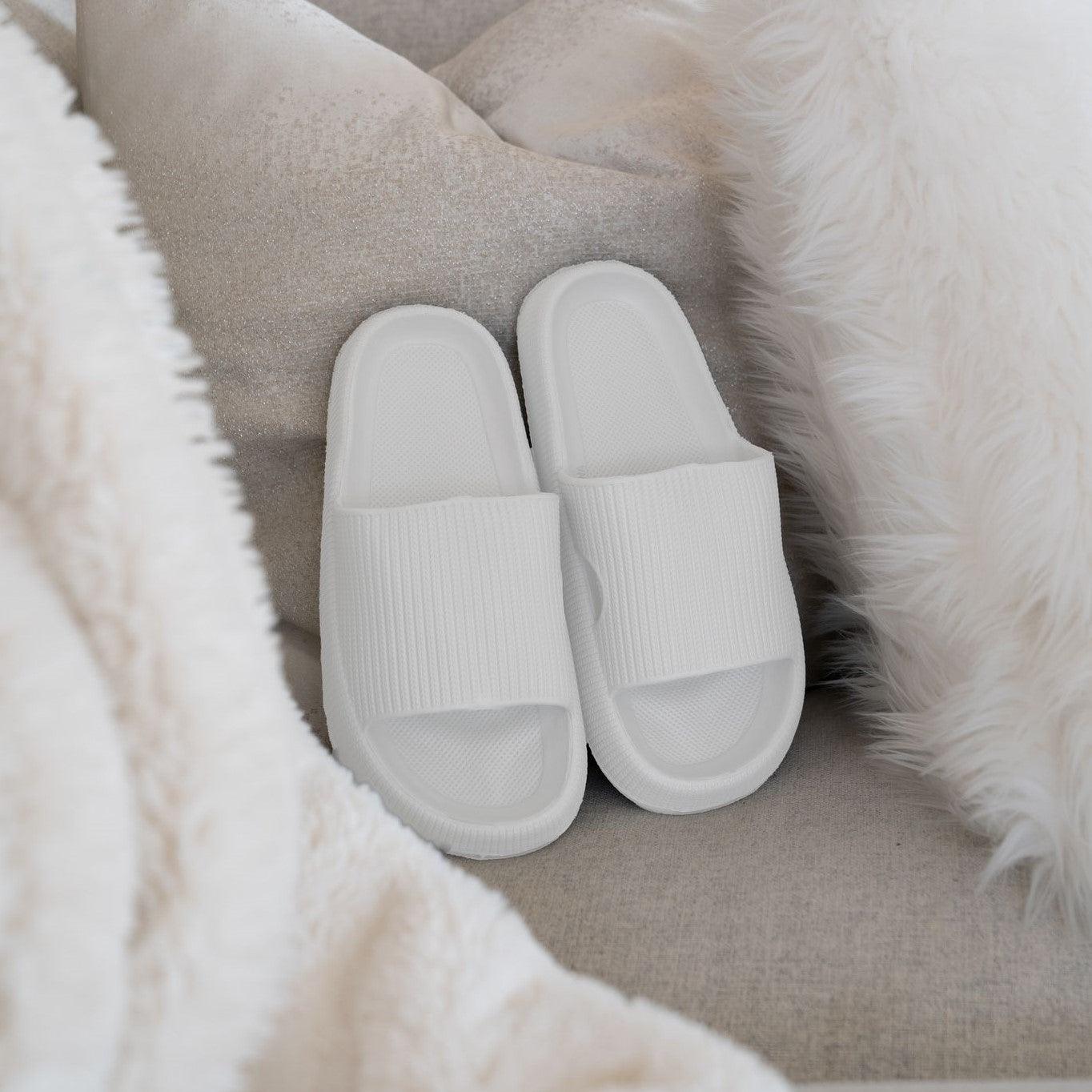 White slip-ons on couch between pillows