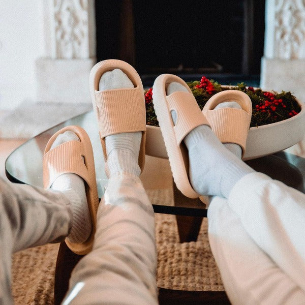 Family slippers in living room by fire place