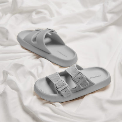Grey sandal slippers on bedsheet